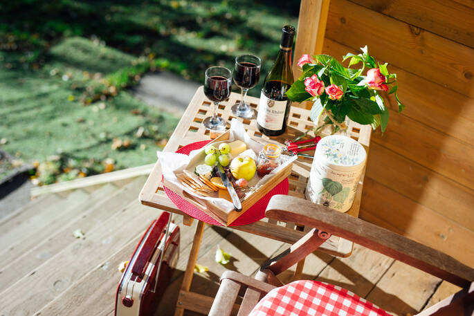 Enjoy red wine, cheese and grapes sat outside Fairfield Shepherd's hut at Acorn Farm in Devon 