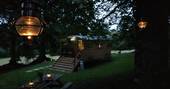 Sit outside as the lanterns brighten the night sky outside of Fairfield shepherd's hut at Acorn Farm