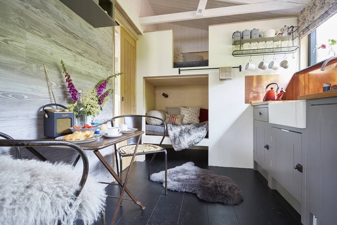 Kids can get snug in the cabin style bunk beds next to the kitchen living space of Brownscombe Cabin in Devon