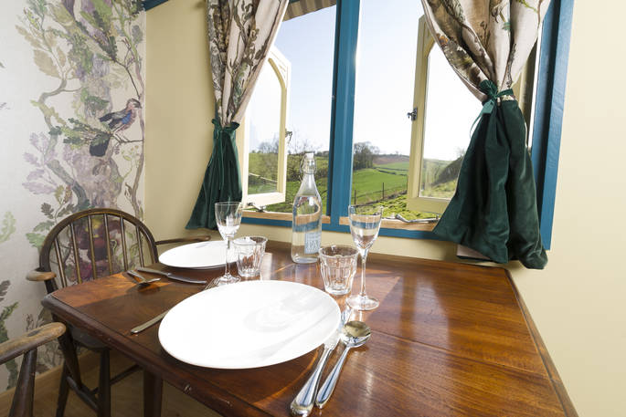 The dining table inside Brownscombe Tabernacle with views of Devon countryside 
