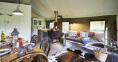 The beautifully fitted living space with kitchen and log burner at Tamar safari tent in Devon