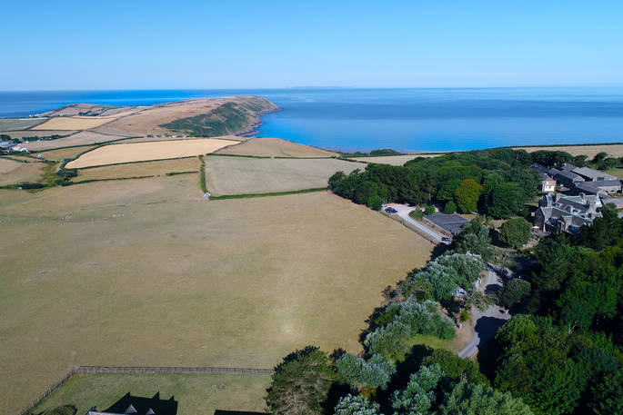 Aerial view of the sea and Pickwell Manor in Devon