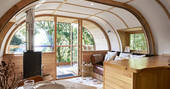 View out from the living room of the surrounding woodland at The Hideaway at Pickwell treehouse in Devon