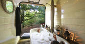Sit in the bath with a glass of bubbly and endless views of the woodland at Sapperton Yurt in Gloucestershire
