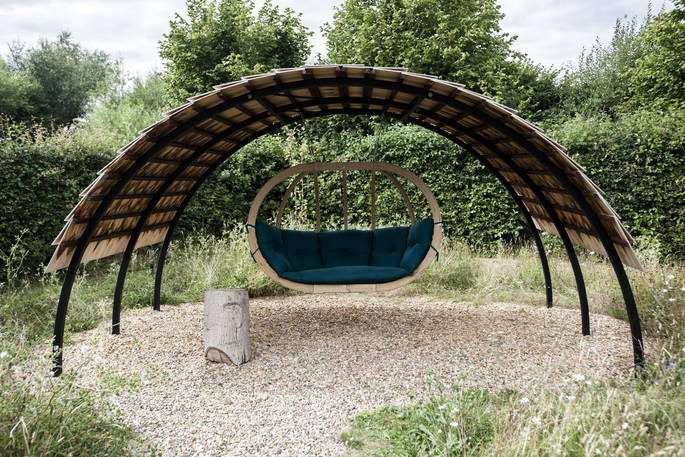 Relax with a book in the hammock swing at The Secret Garden camp in Hertfordshire