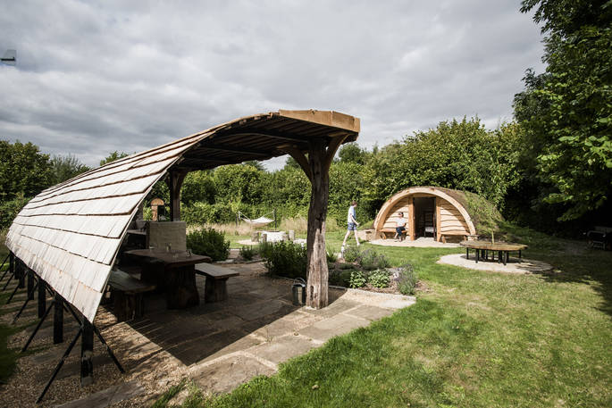 The covered outdoor kitchen at The Secret Garden camp with herb garden