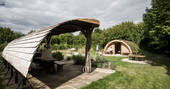 The covered outdoor kitchen at The Secret Garden camp with herb garden