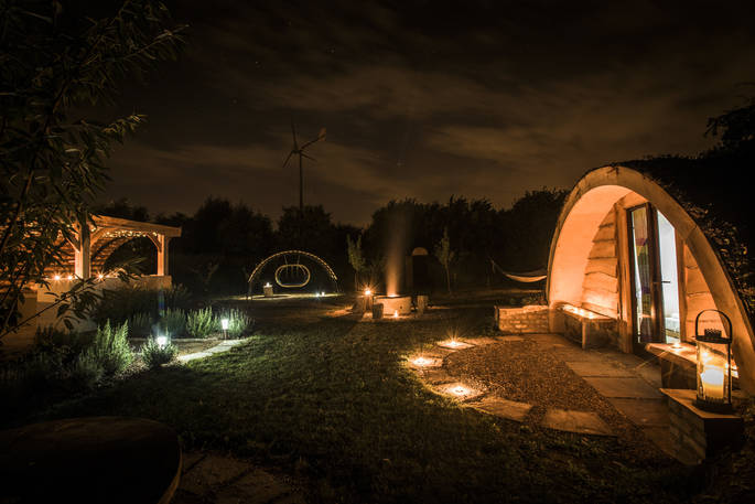 The Secret Garden camp at Guilden Gate at night with the outside fire pit providing warmth and a place to gather together