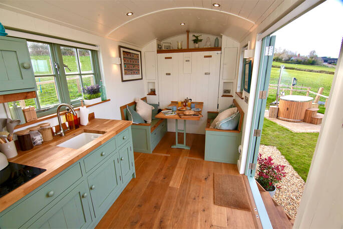 Oak Hut at Shropshire Shepherds Huts dining area that converts into a double bed