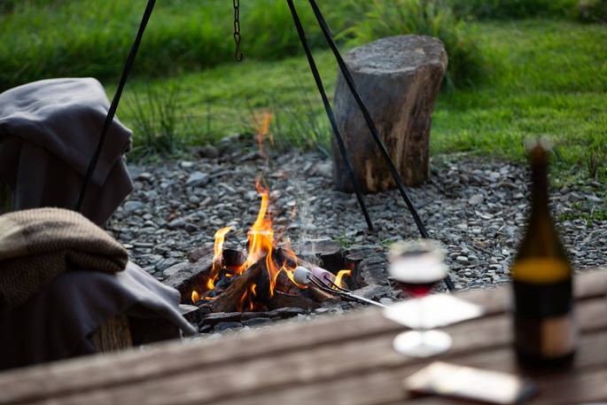 Gather together around the campfire at One Cat Farm in Ceredigion, Wales