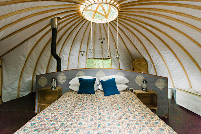 The comfortable kingsize bed inside Catta Dee tent at Penhein Glamping in Monmouthshire