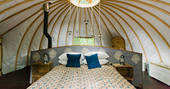 The comfortable kingsize bed inside Catta Dee tent at Penhein Glamping in Monmouthshire