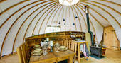 Dining area and kitchen inside Catta Dee tent at Penhein Glamping in Monmouthshire